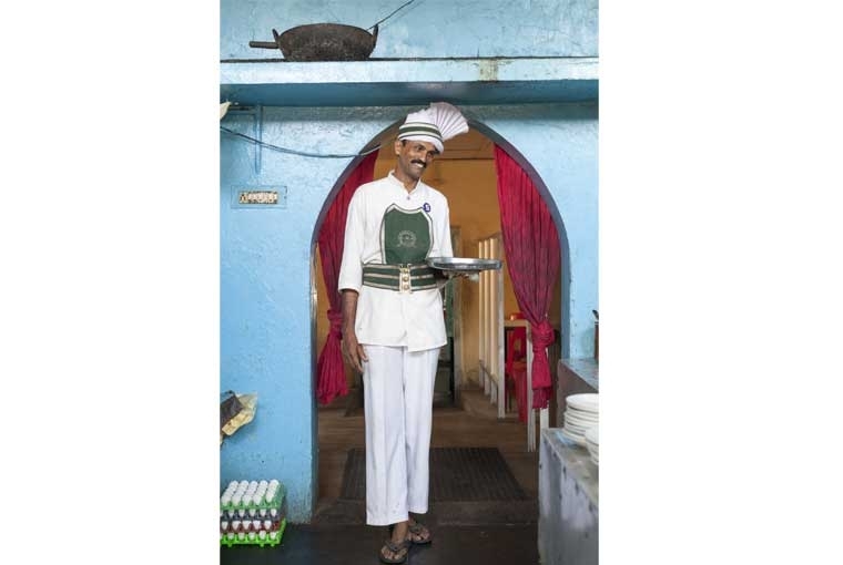 The Palaces of Memory ©Stuart Freedman, Sangaran, a waiter who has worked at the coffee shop for 17 years. The Indian Coffee House, Kollam (now closed), 2013, C-type print Courtesy Tasveer