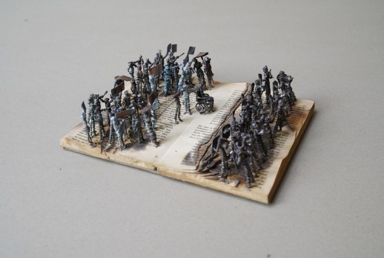 Blueprint12 at Art Mumbai 2025  Kingsley Gunatillake Protest II, 2024 Used books & Copper figures 2 1/2 x 7 1/8 x 8 5/8 in 6.5 x 18 x 22 cm