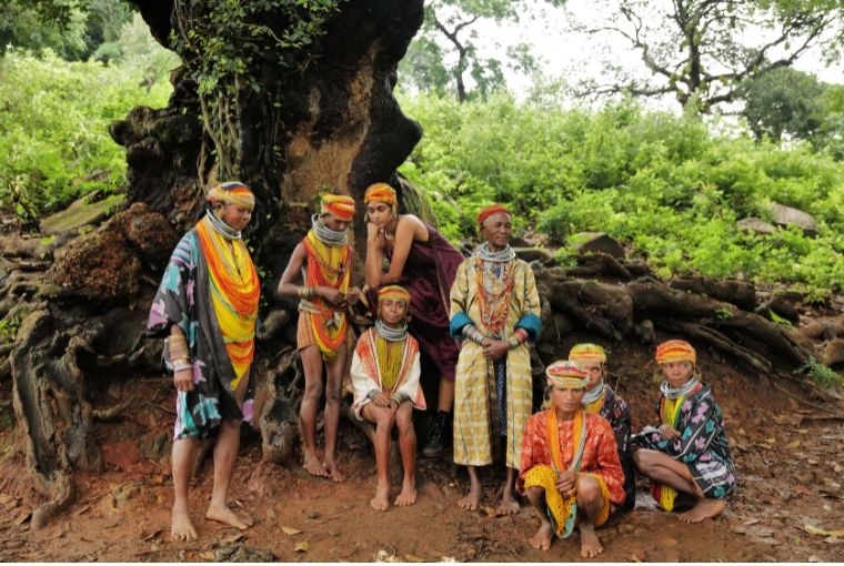 Boito Women from the Bonda tribe - whose ancestors migrated from Africa over 60,000 years ago - stand under a jackfruit tree with Boito model Varsha wearing Boito's creations and their traditional headgear