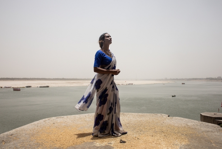 Daniela Agostini Rupa poses for portrait in front of the Ganges river in Varanasi, India.