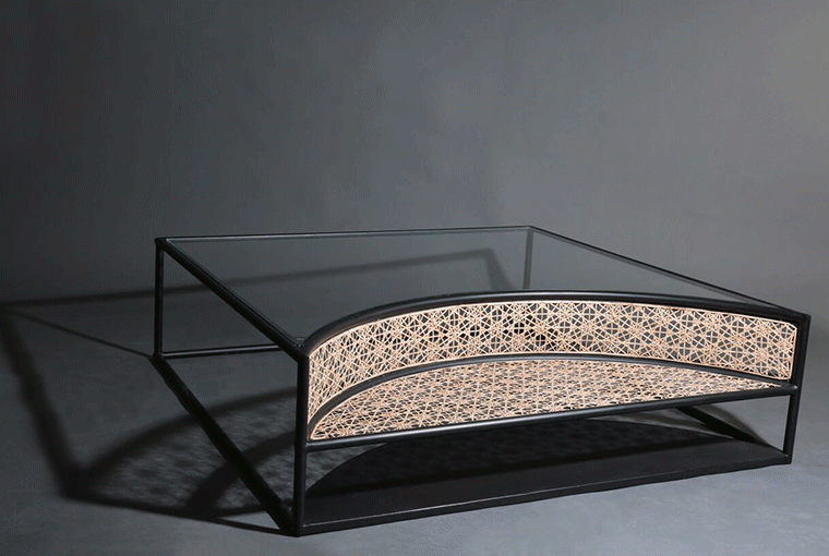 Figments Imagined as a cuboidal wireframe, this table cuts through with a balanced semi-circular curve at two levels showing the waxing moon in cane with shadows in black metal.