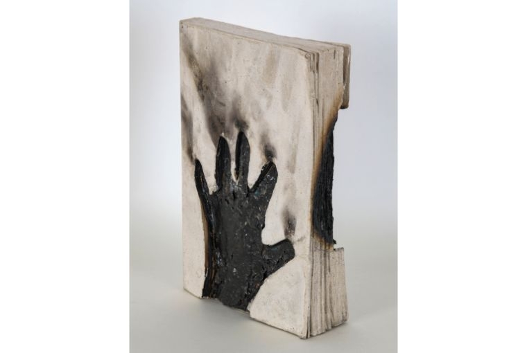 Saba Hasan  A Child’s Voice, 2024. Clay and ash on book, Collection: Saba Hasan studio